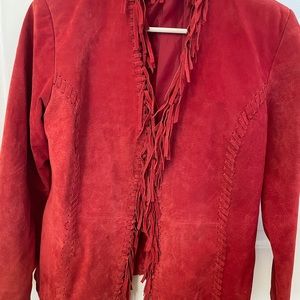 Red fringed jacket is Swede like material. The contents do not say Swede.